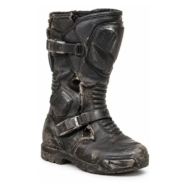 Motorcycle riding boot before professional repair